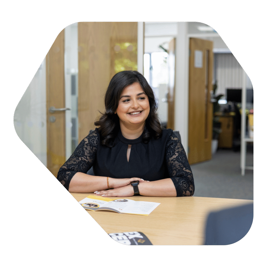 Woman at desk discussing a UK Spouse Visa