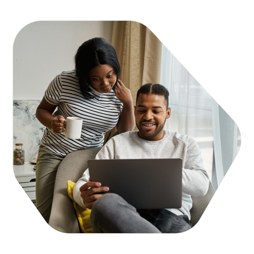 Couple looking into Spouse Visa UK Solicitors on a laptop
