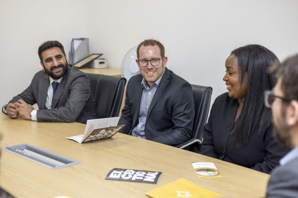 Law Firm Diversity. People working around a table
