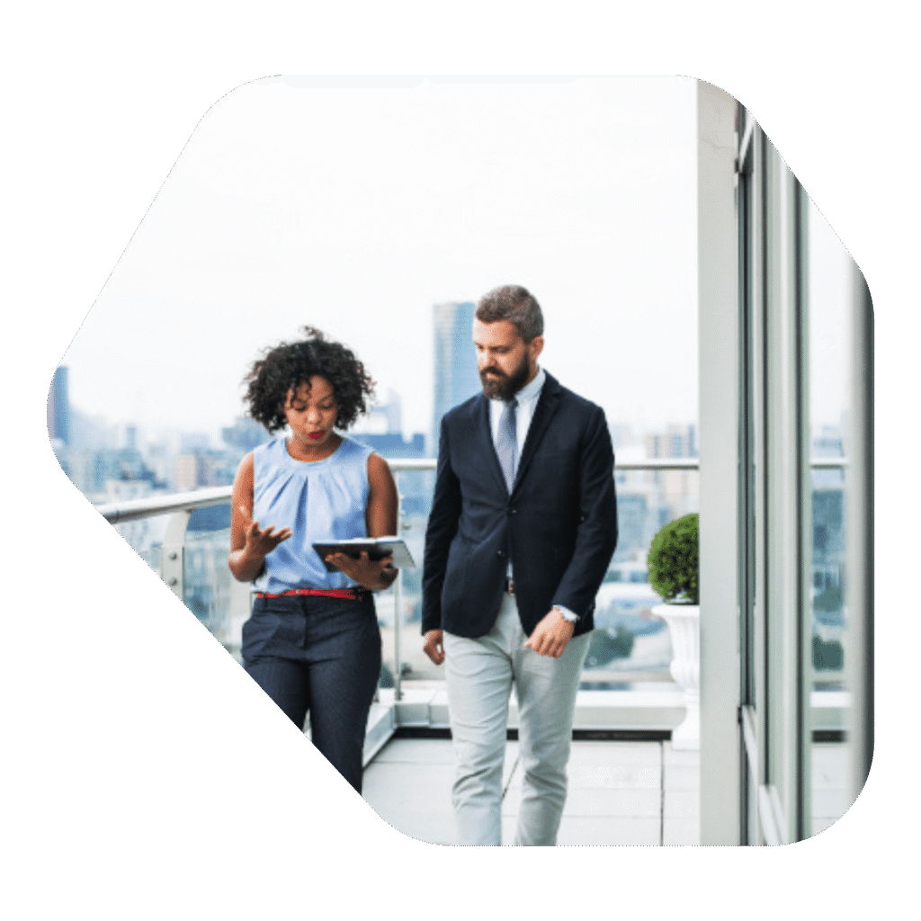 Business man and woman discussing when to apply for a sponsor licence