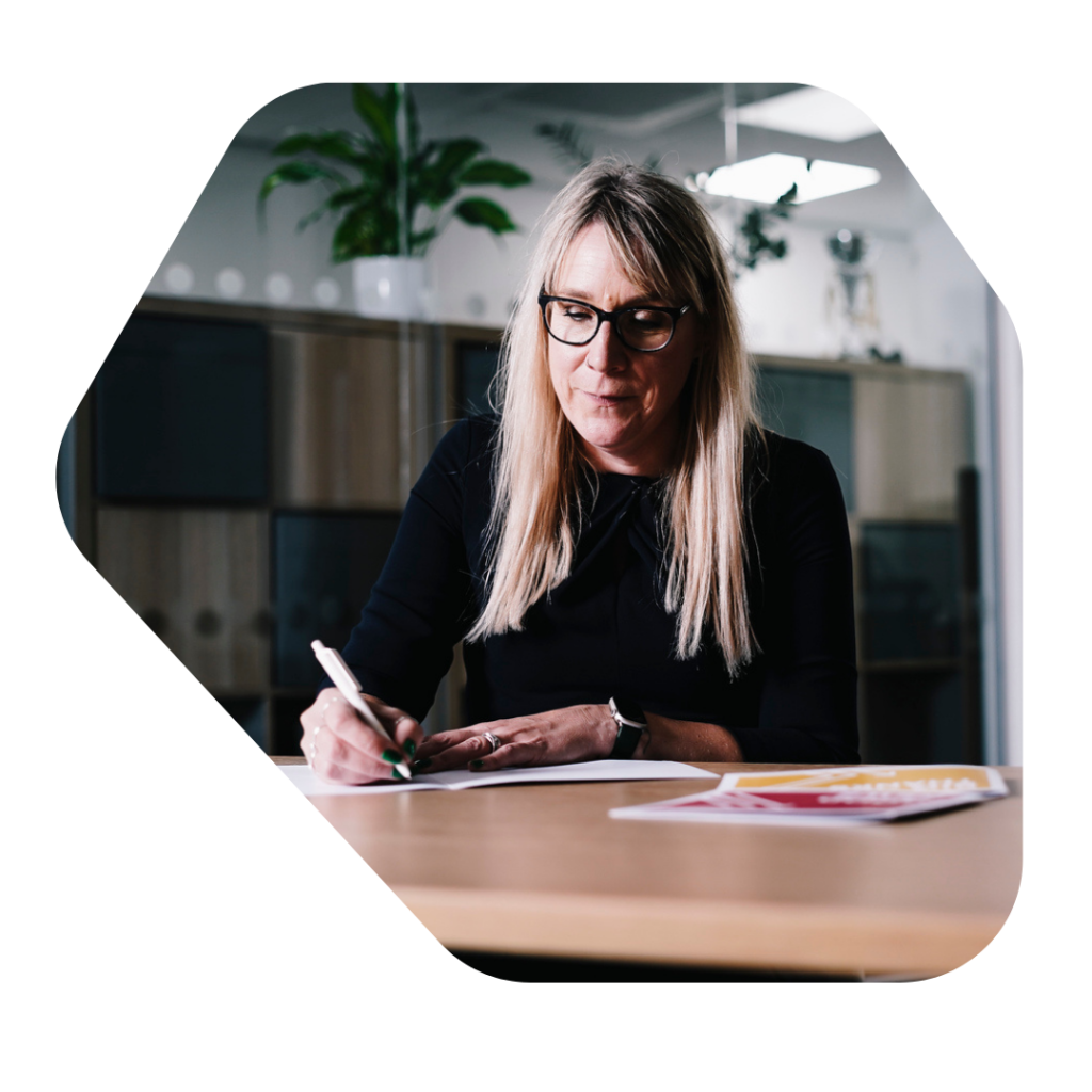 Female solicitor writing documents about sponsor licence compliance
