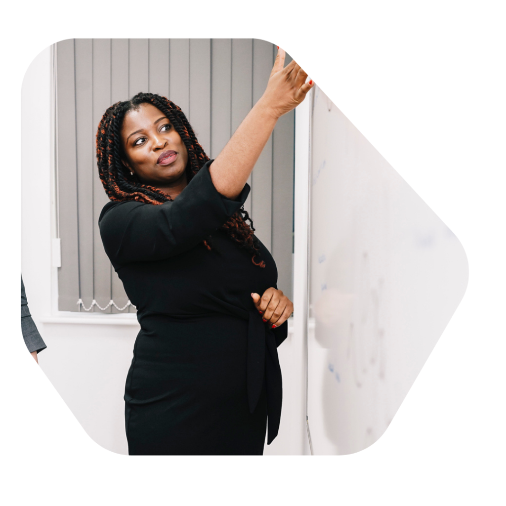 Indefinite Leave to Remain UK Spouse Solicitor pointing at a whiteboard